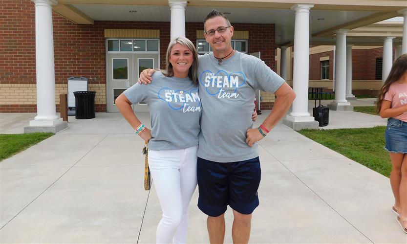 Two teachers smile